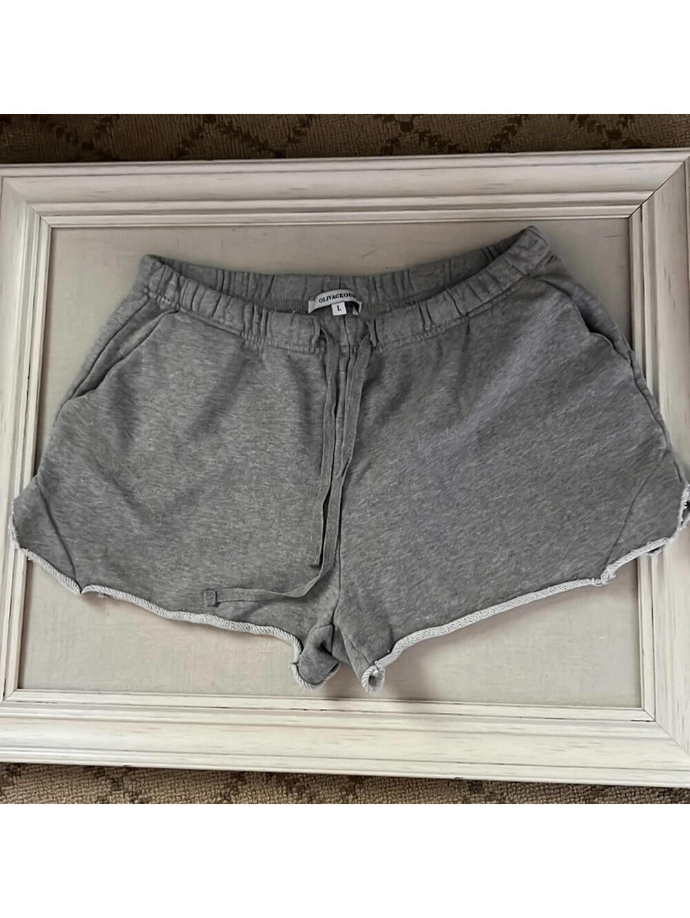 Olivaceous gray distressed sweat-shorts with rolled hems and pockets. NWOT L